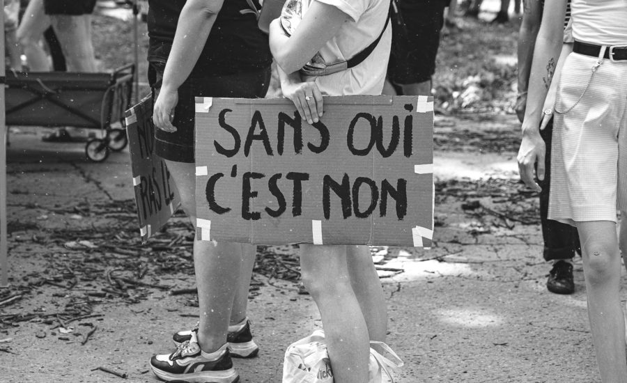 grayscale photo of man and woman holding love you printed board